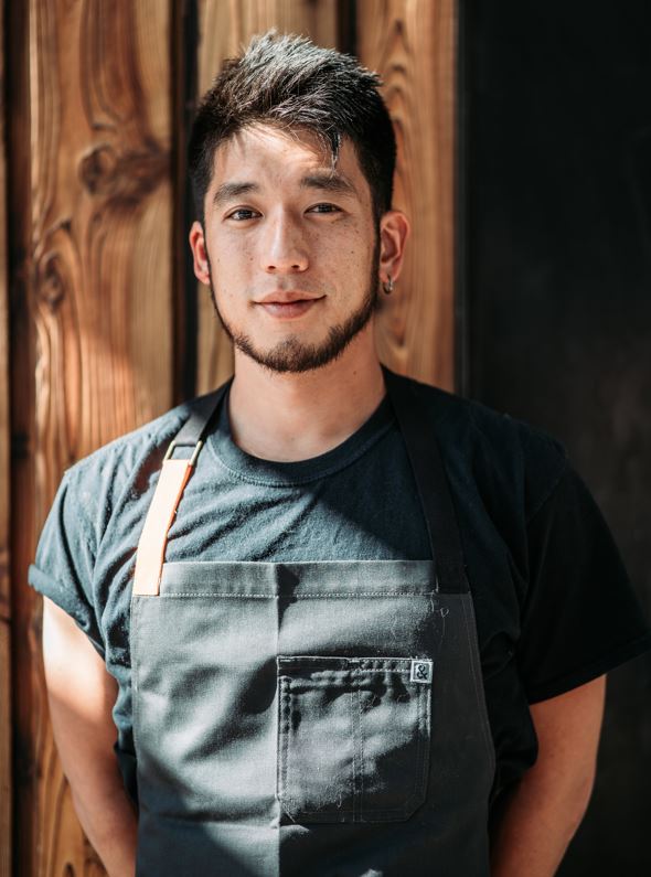 Chef Shota headshot in front of wooden background