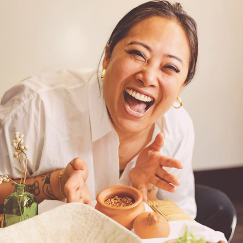 chef Melissa Miranda laughing with food in front of her