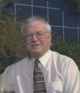 Photo of Dr. Bressler in front of the campus center I building
