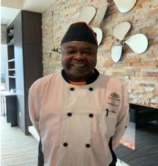 Executive Chef Larry Carter smiling in his uniform